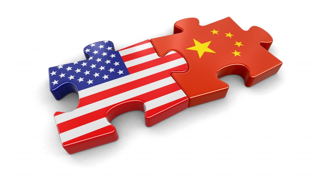 Puzzle pieces featuring the flags of the United States and China interlocking together.