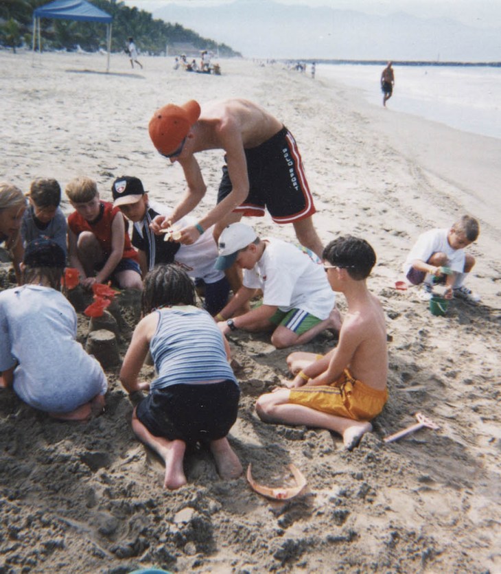Photo of children building a sandcastle, about 1980. The Strong, Rochester, New York.