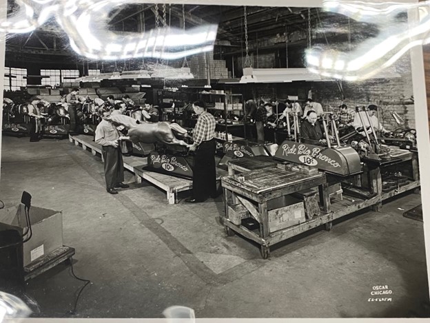 Picture ofWorkers assembling Big Bronco kiddie ride inside of Exhibit Supply Co., Chicago, I, about 1940s-1950s. Larry Bieza collection, Brian Sutton-Smith Library and Archives of Play at The Strong National Museum of Play, Rochester, New York.