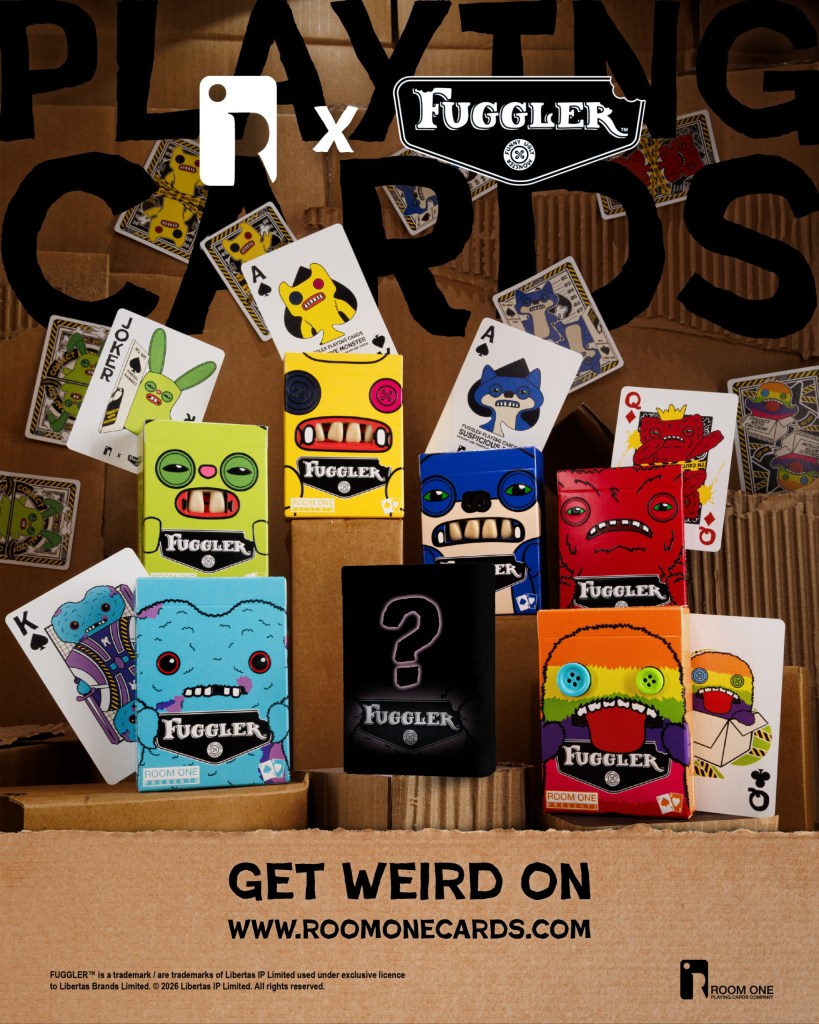 Promotional image for Fuggler playing cards, featuring various colorful card designs, including jokers and kings, against a backdrop of cardboard boxes.
