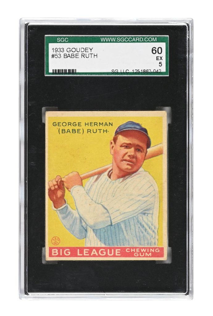 A 1933 Goudey baseball card featuring Babe Ruth, identified as George Herman Ruth, in a batting stance. The card is encased in a protective holder, with labels indicating its grade and information.